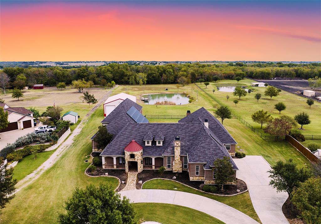 an aerial view of residential houses with outdoor space and swimming pool