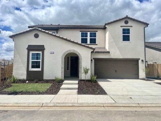 a front view of a house with garage