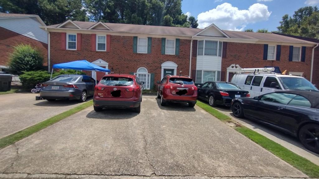 a couple of cars parked in front of a house