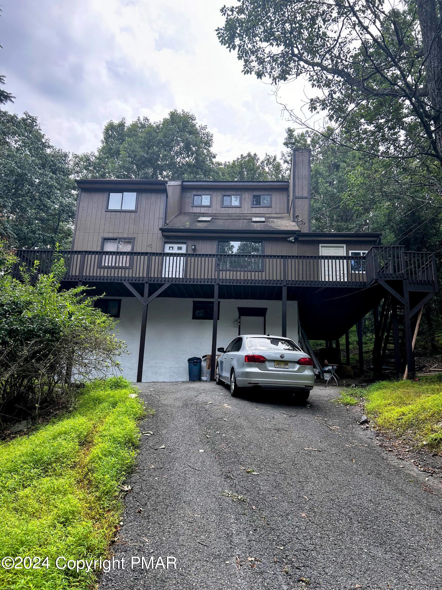 a view of a house with backyard porch and sitting area