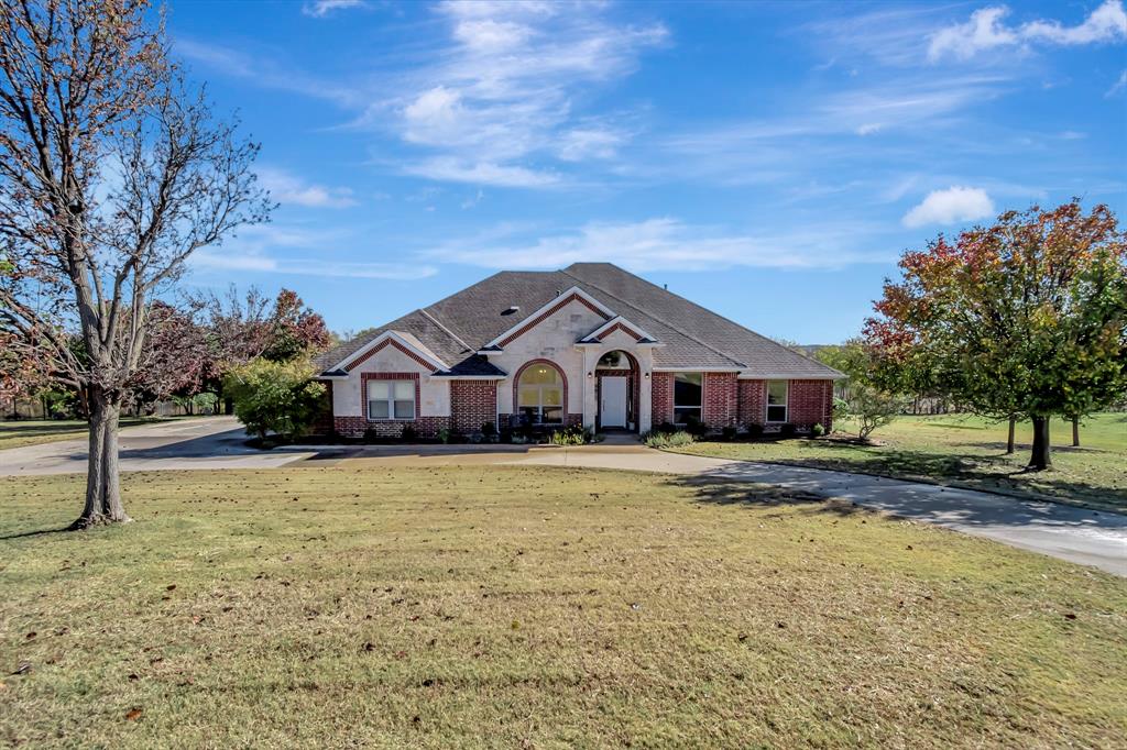 a front view of a house with a yard