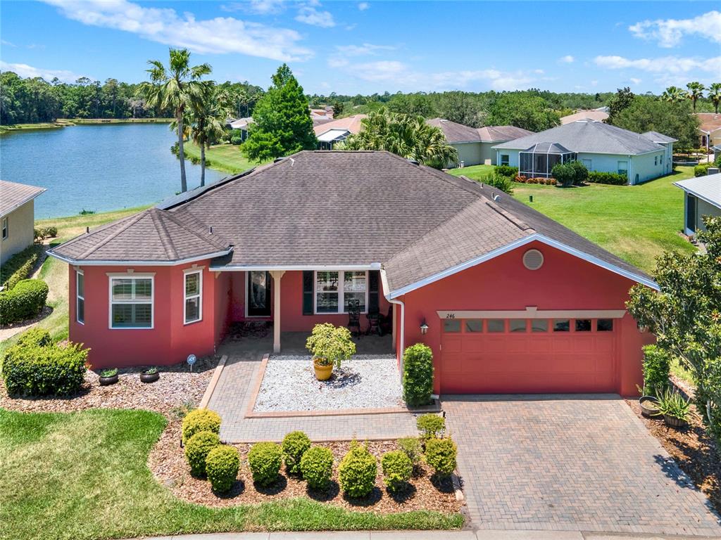 an aerial view of a house with garden space and lake view