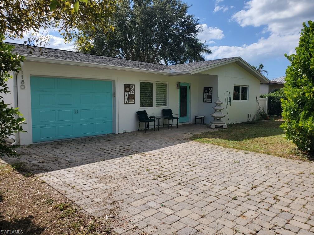 a view of a house with backyard and sitting area