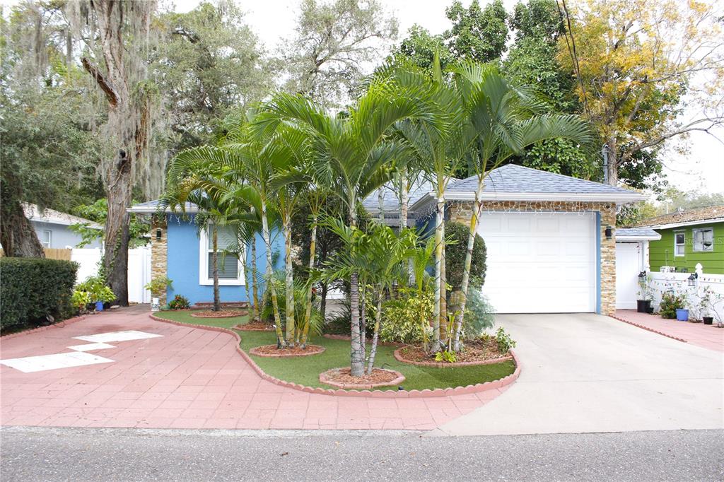 a front view of a house with a yard garage and outdoor seating