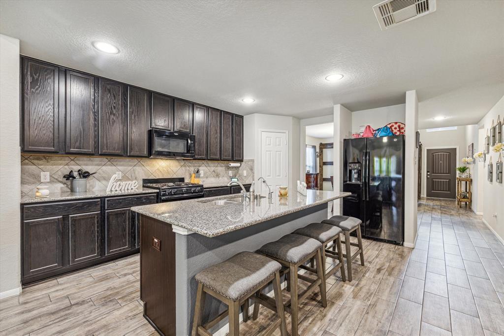 a kitchen with a table chairs refrigerator and cabinets