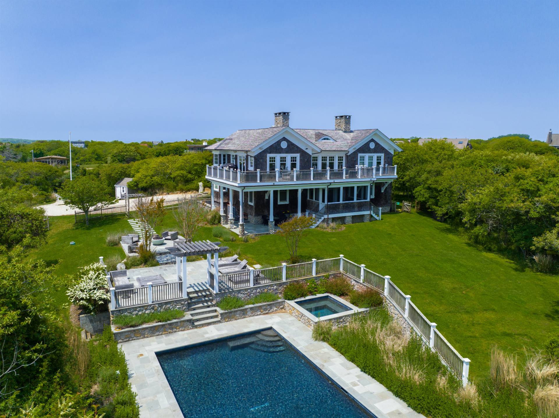 a view of a house with pool and chairs