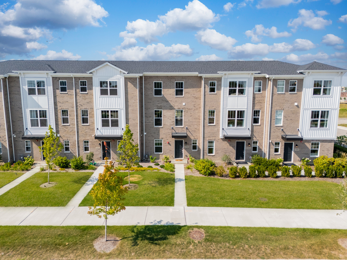 a view of a big yard in front of a brick building