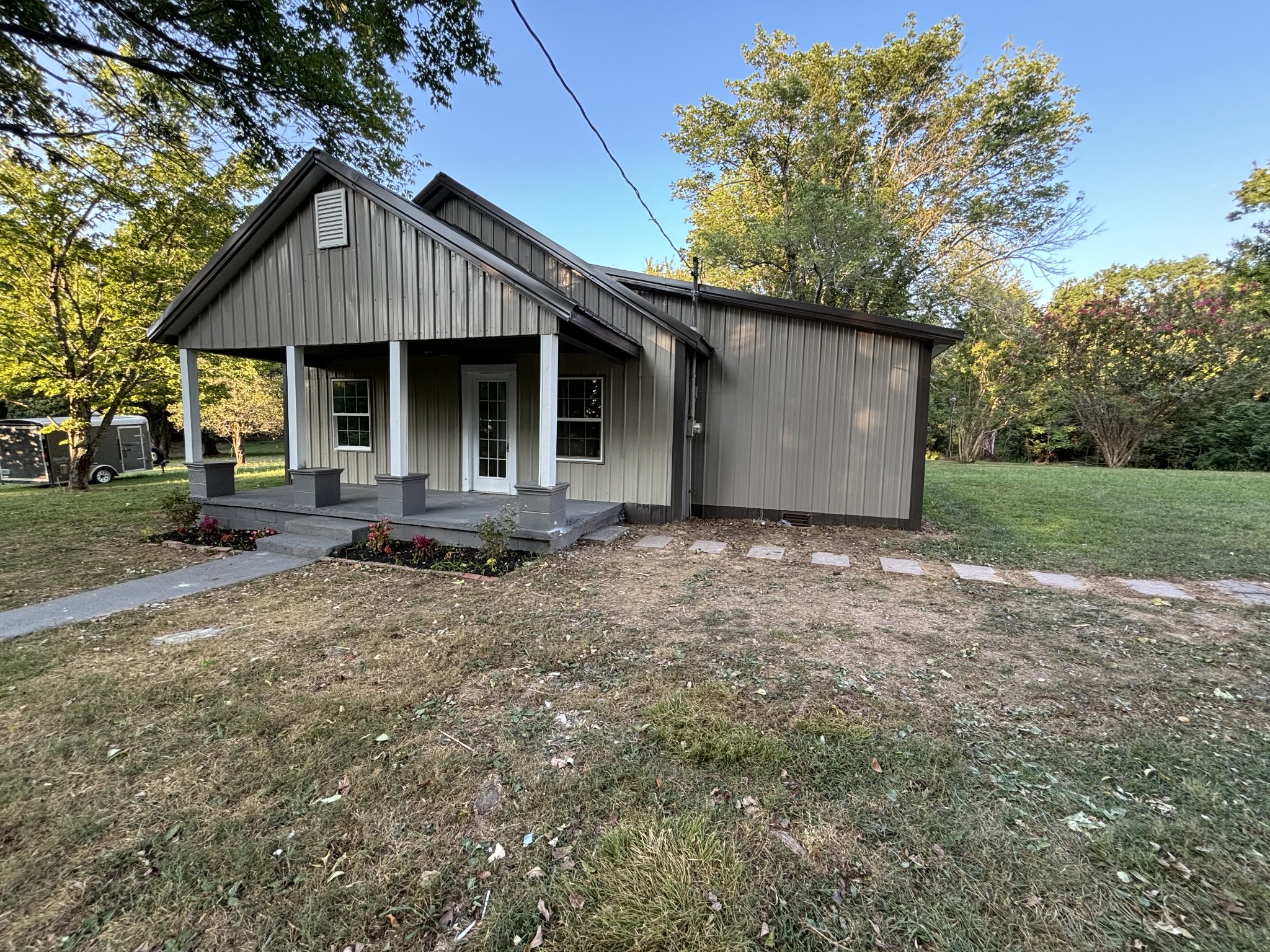 a front view of a house with a garden