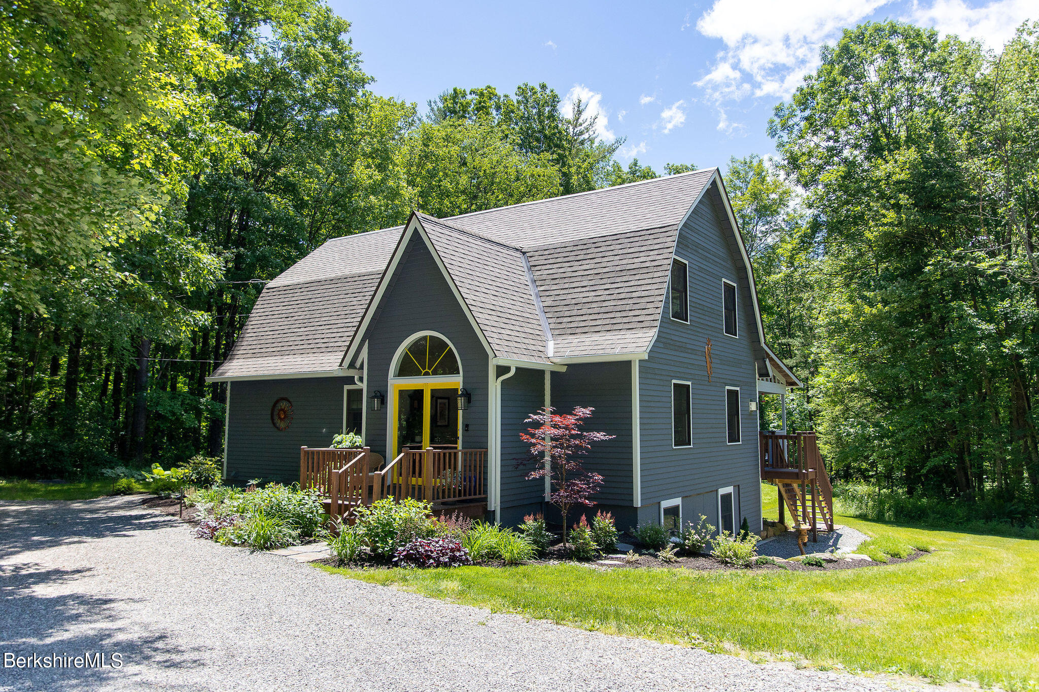 a front view of a house with garden