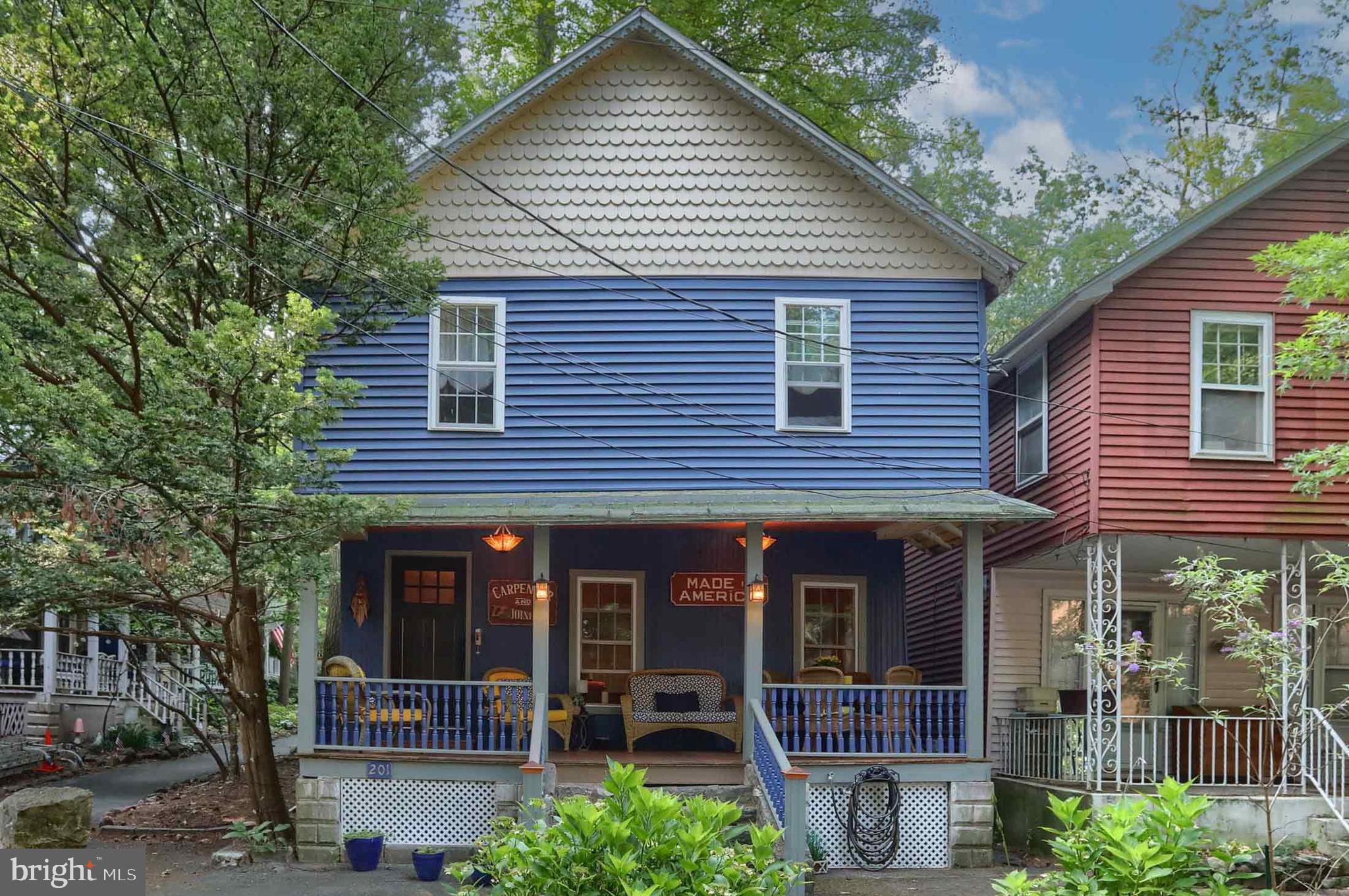 a front view of a house with plants