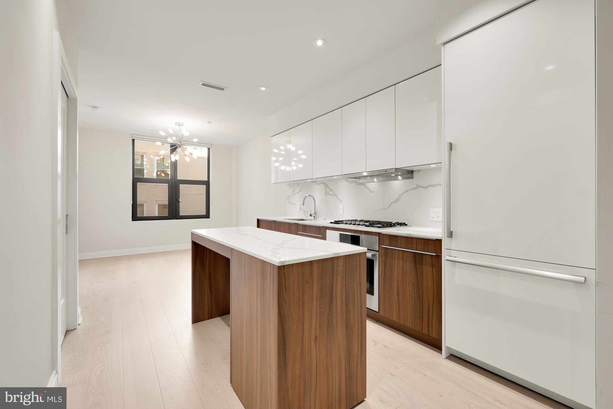 a kitchen with a stove and a refrigerator