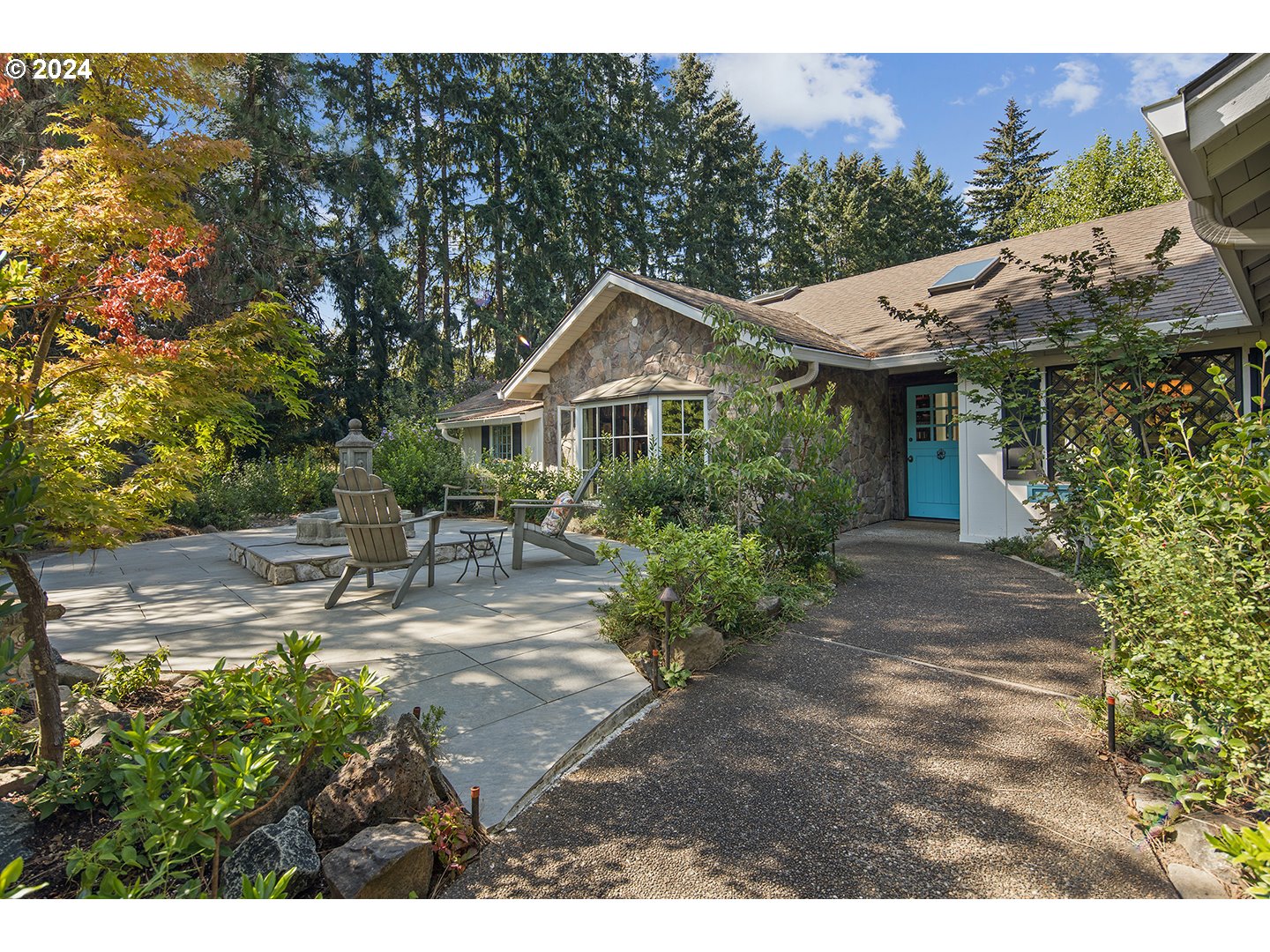 a front view of a house with a garden