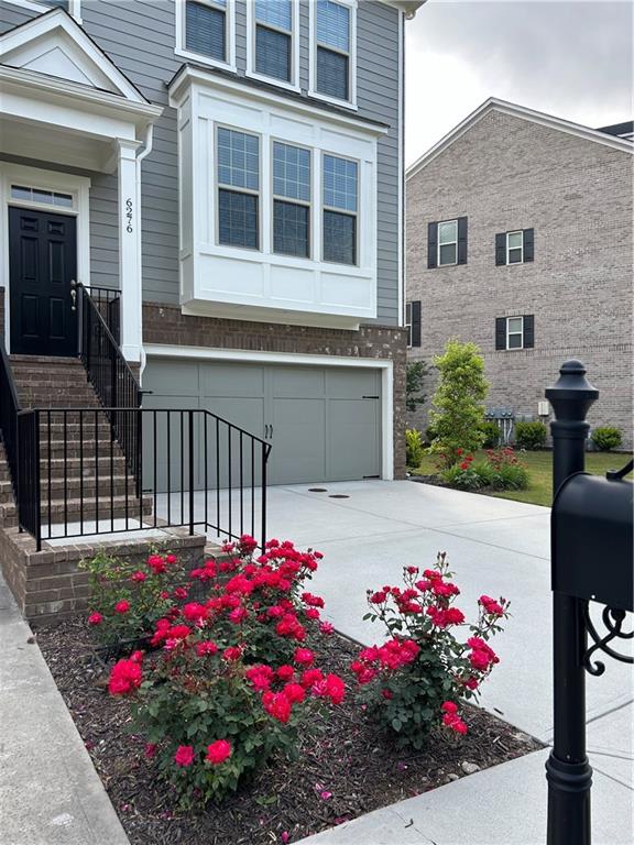 a view of a house with a flower garden