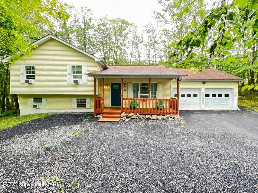 a view of a house with a yard and sitting area