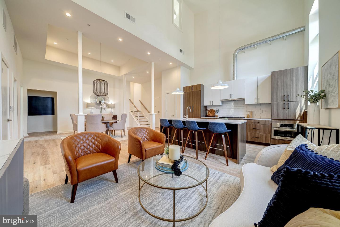 a living room with furniture kitchen view and a fireplace