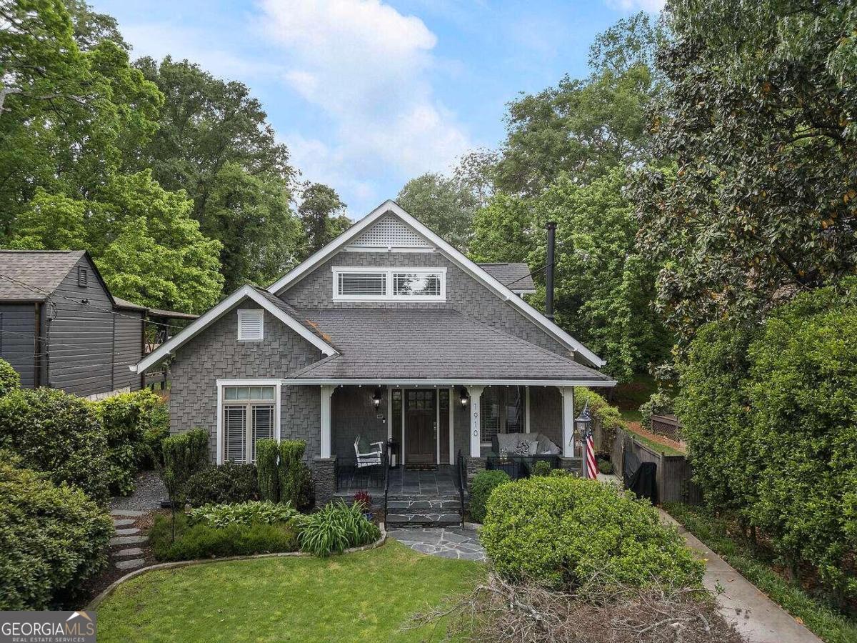 a front view of a house with yard and green space