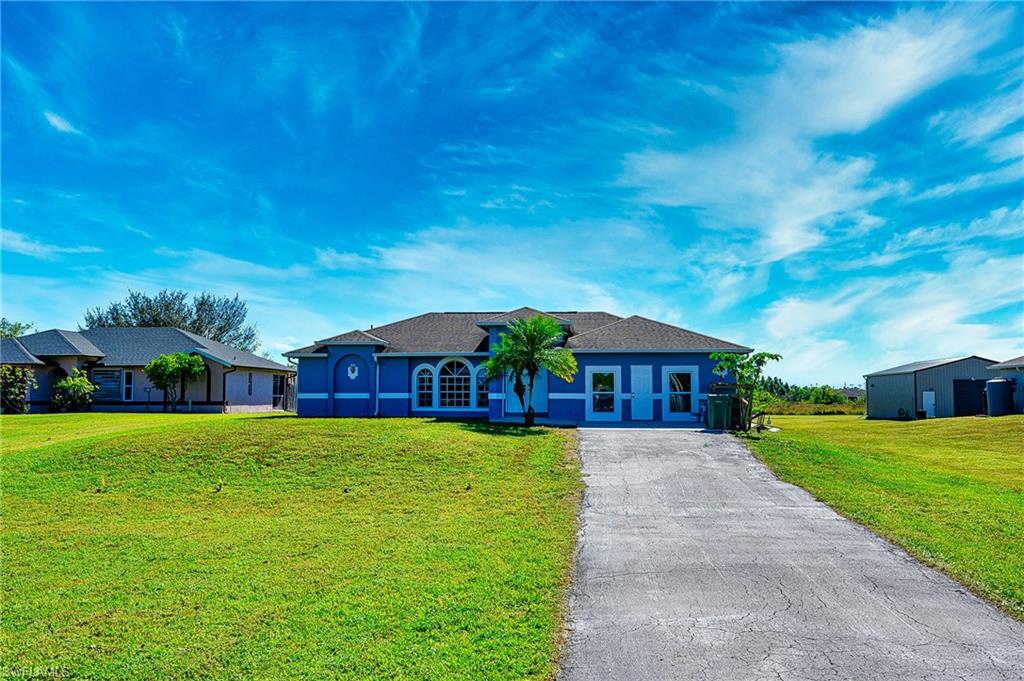 Single story home with a front yard