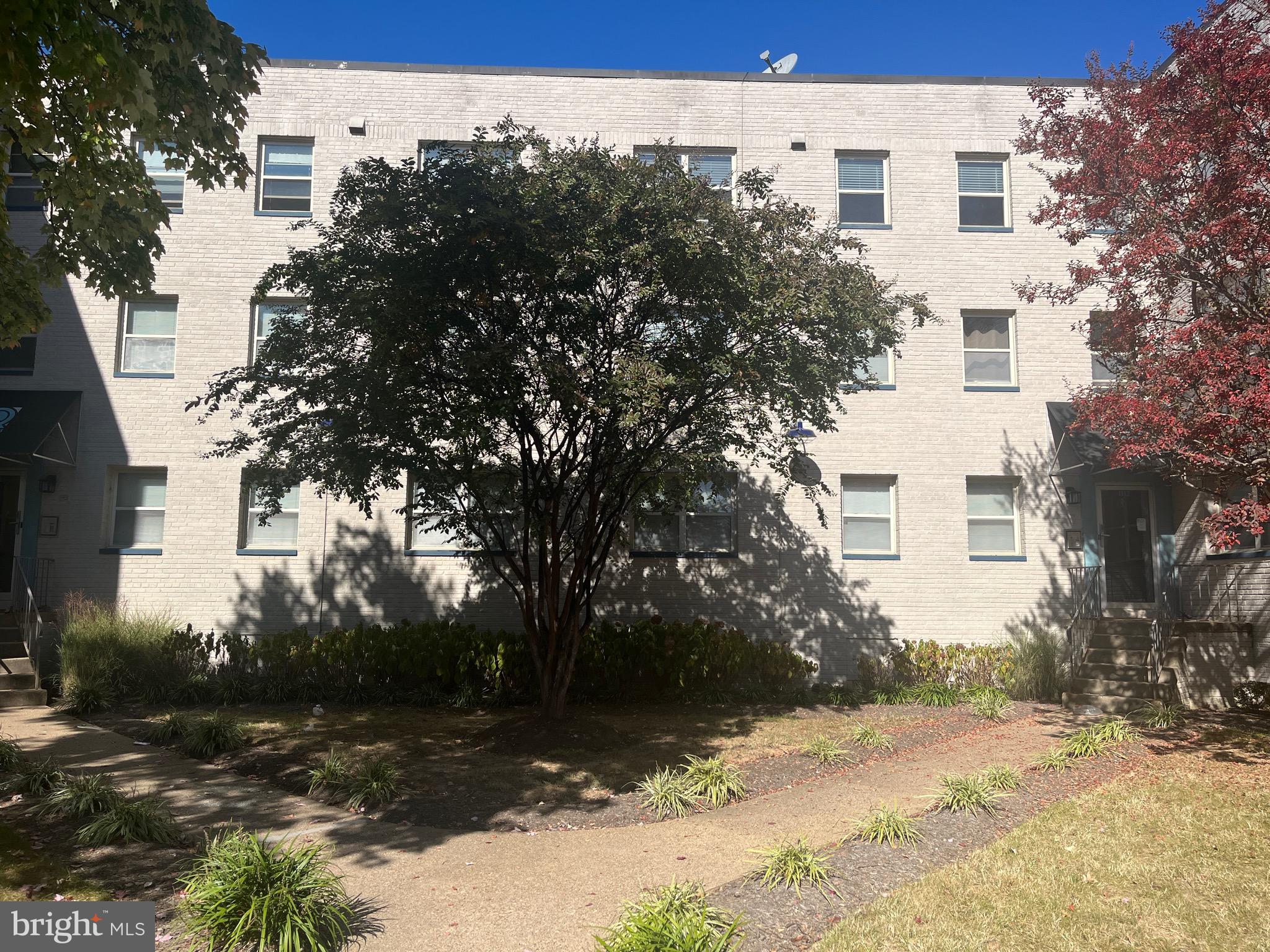 a view of a white house with a yard