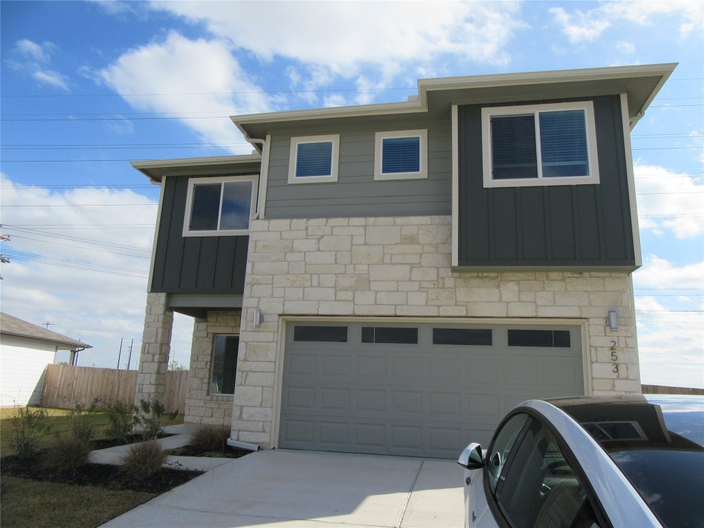 a front view of a house with parking space