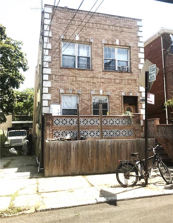 a view of a brick building next to a yard