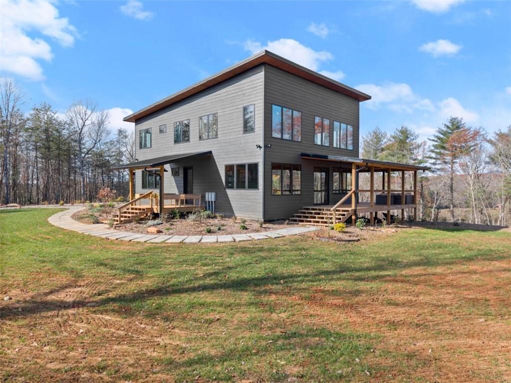 a front view of a house with swimming pool having outdoor seating