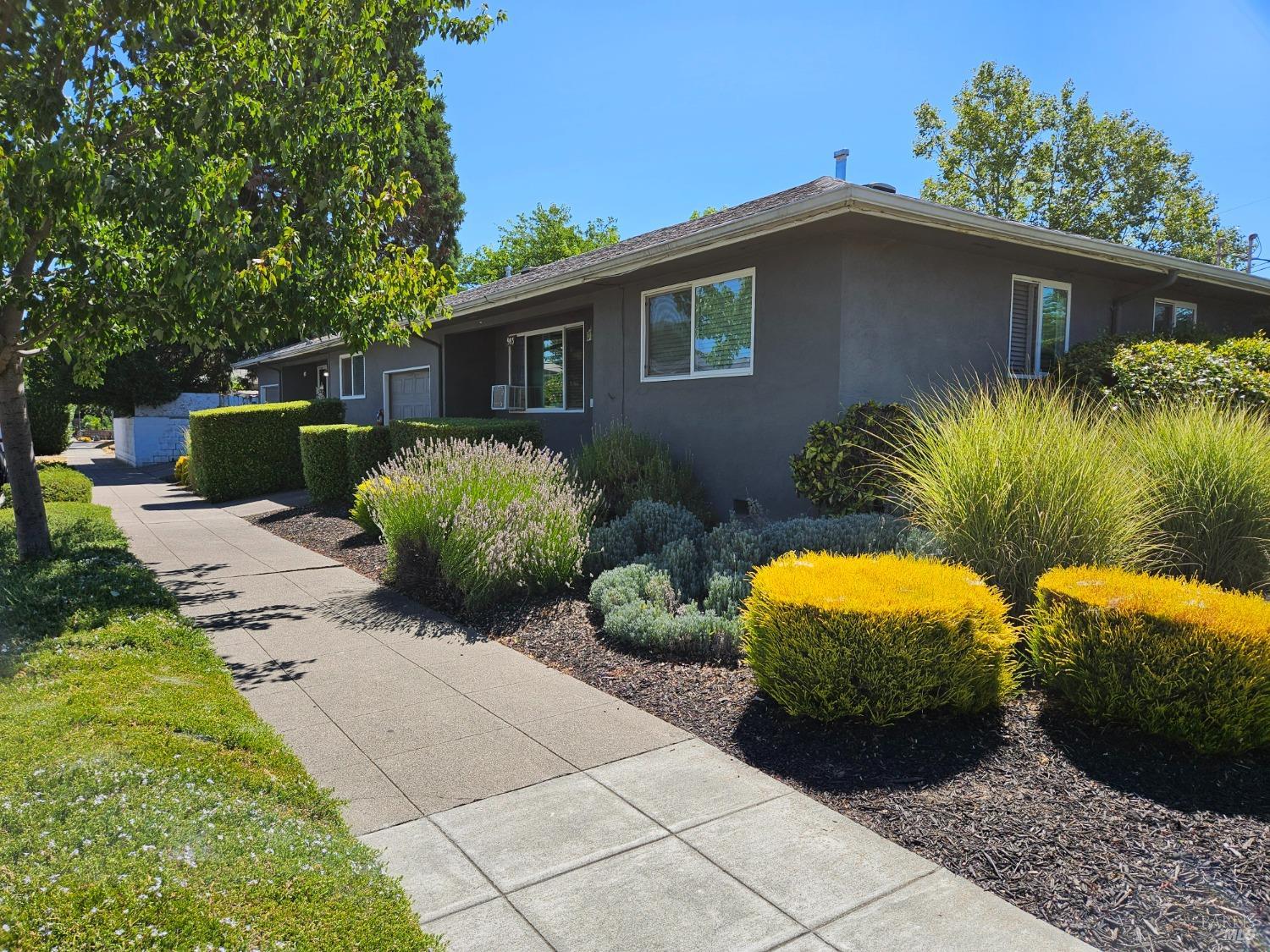 a front view of a house with garden