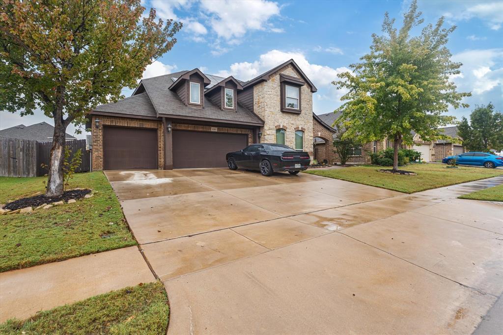 a view of a house with outdoor space and a car parking area