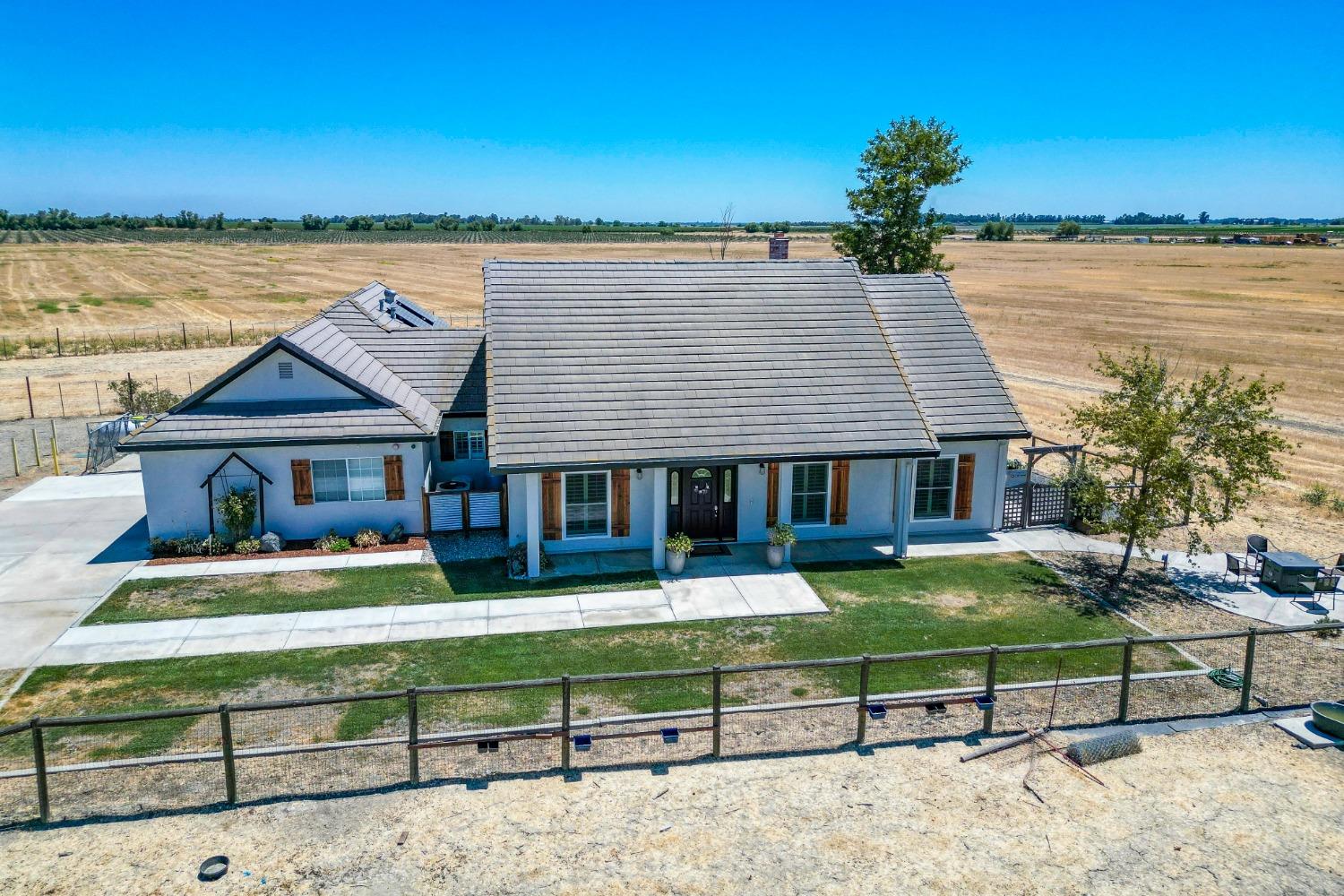 an aerial view of a house with swimming pool garden view and a lake view