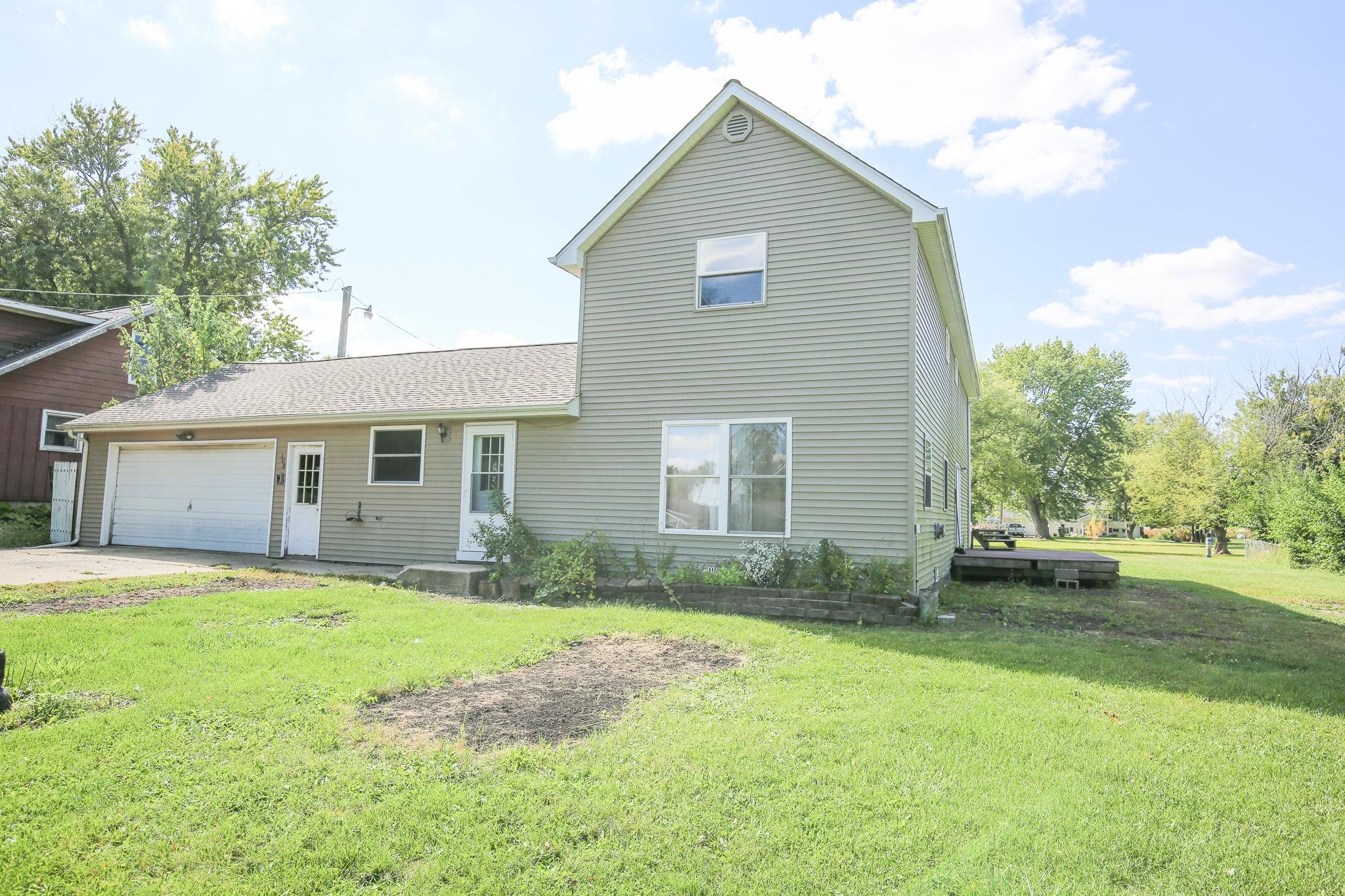 a front view of house with yard and trees