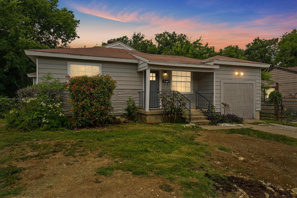 a view of a house with yard and a garden