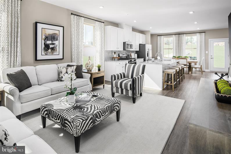 a living room with furniture a dining table and a window