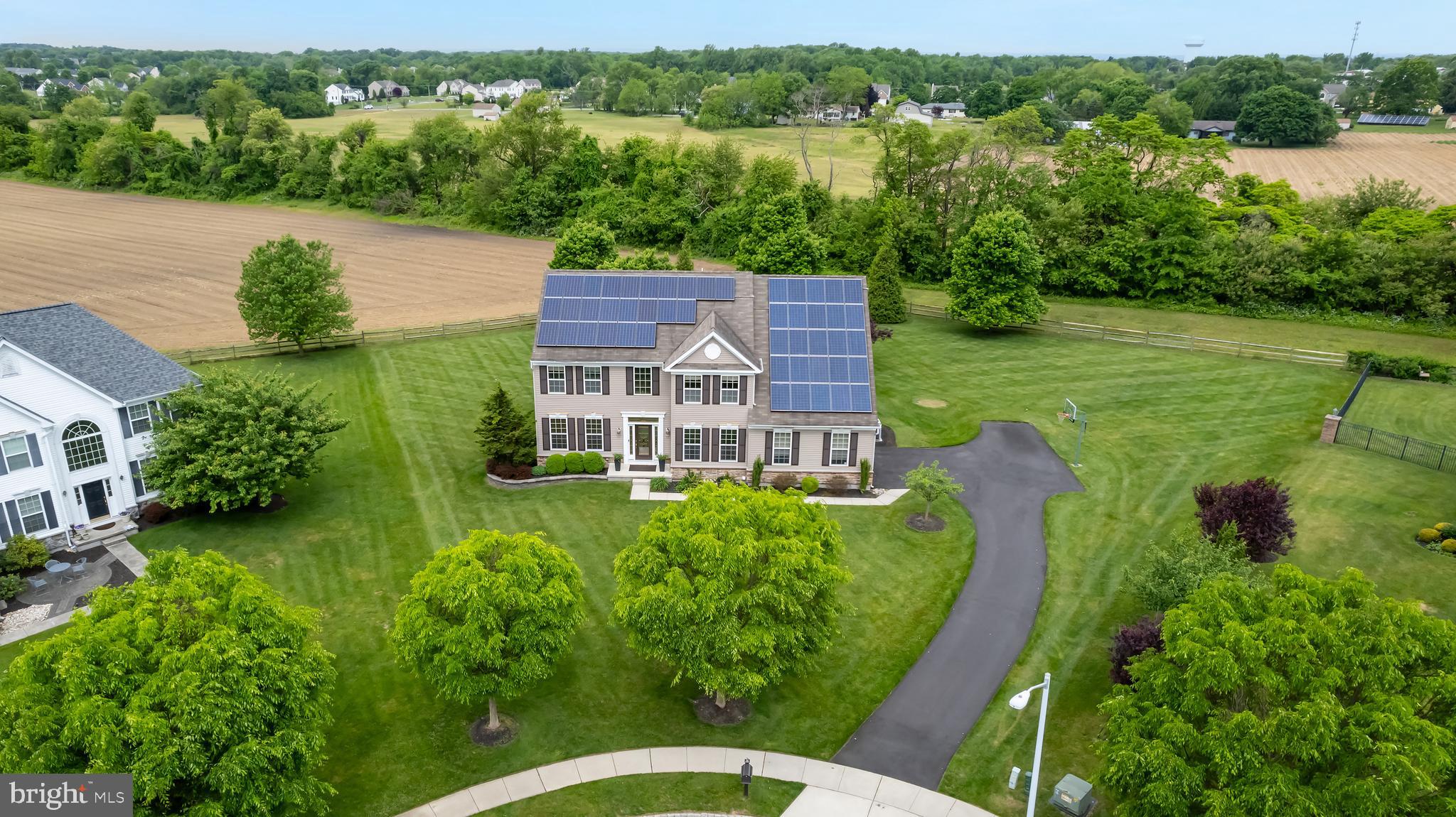 an aerial view of a house with pool garden and outdoor seating