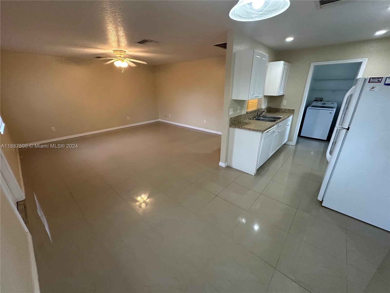 a kitchen with kitchen island a counter top space appliances and cabinets