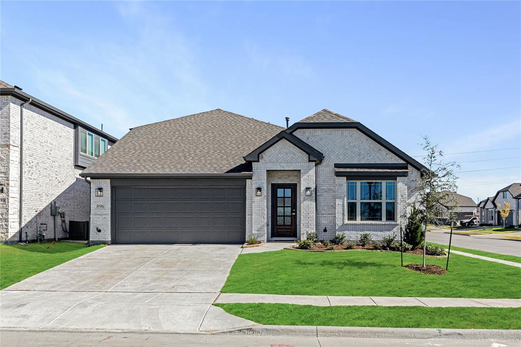 a front view of house with a garden