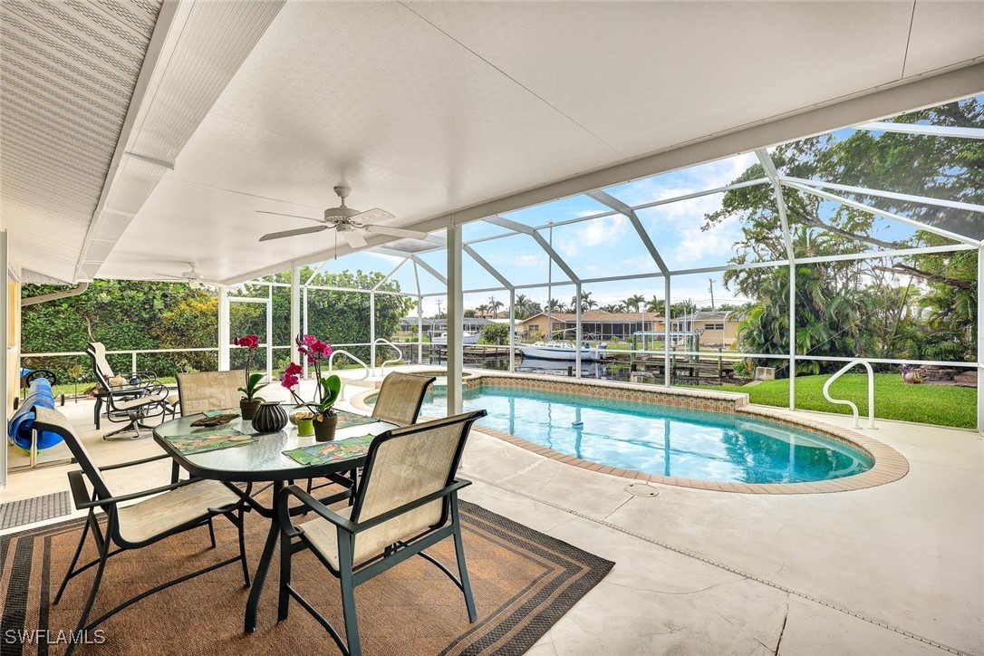 a view of a swimming pool with a table and chairs