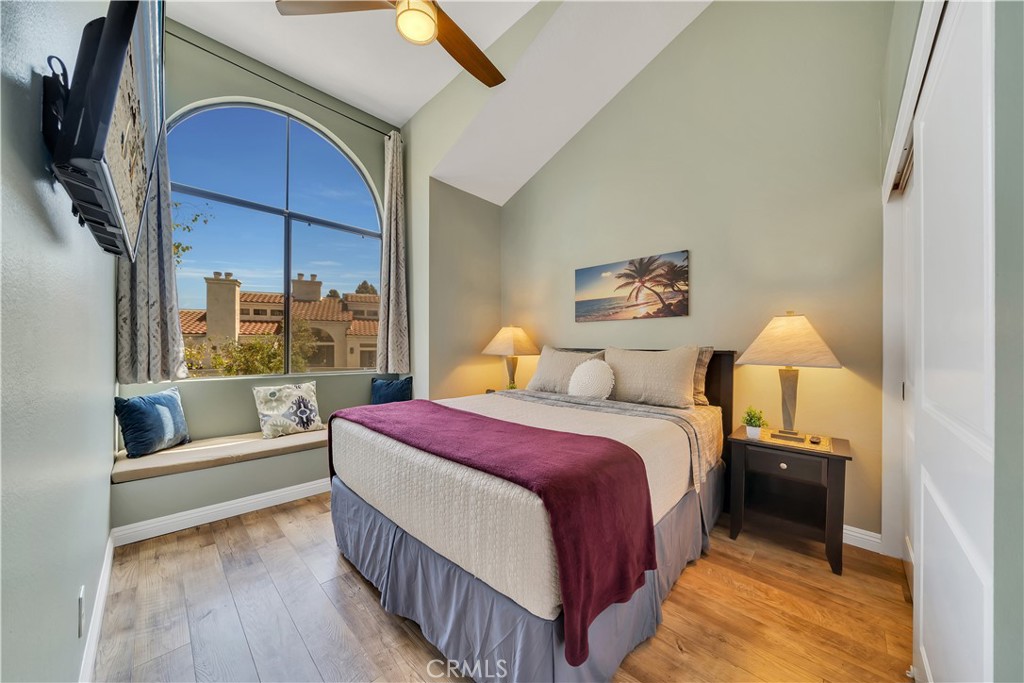 a bedroom with a bed and a large window