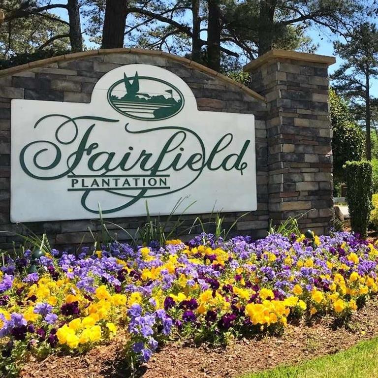 a street sign that is in front of flowers