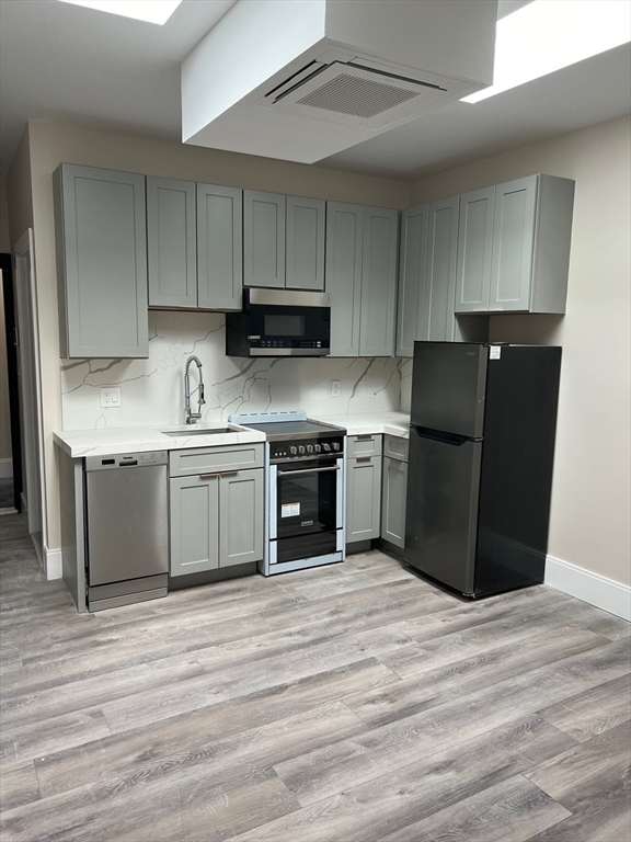 a kitchen with a cabinets and steel stainless steel appliances