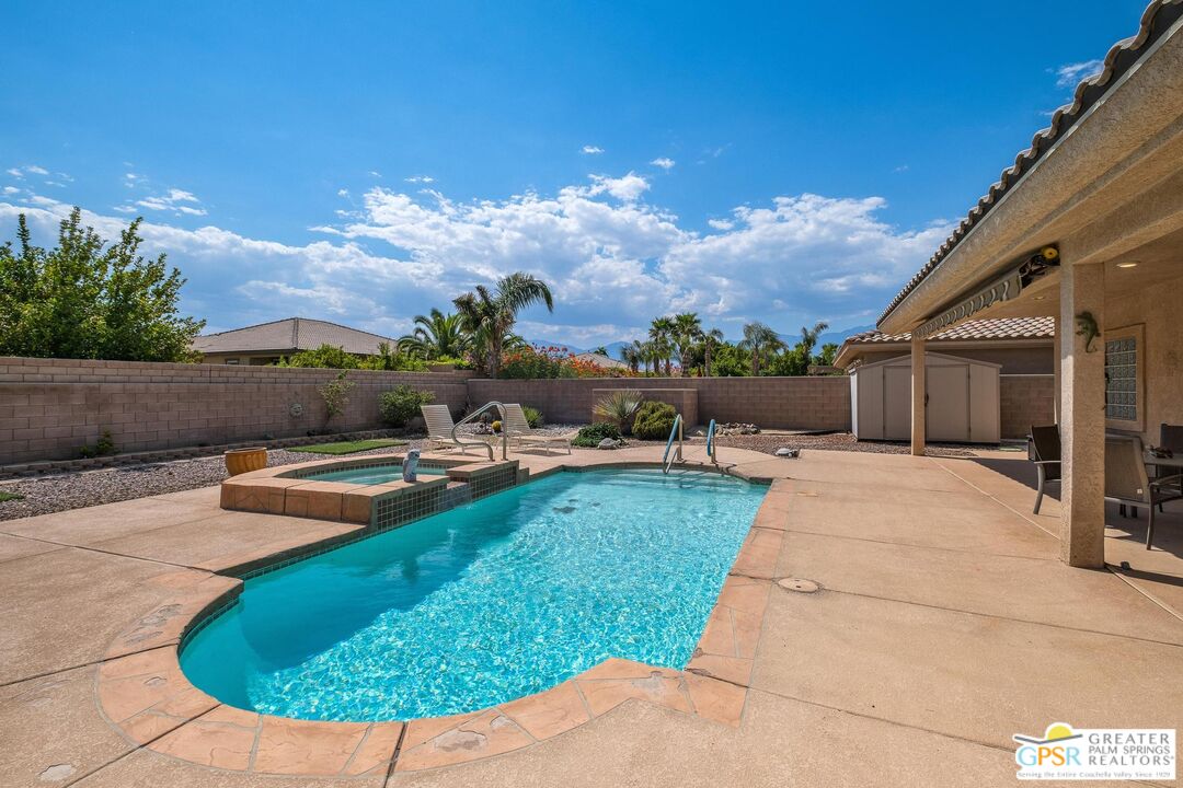 a view of a backyard with sitting area