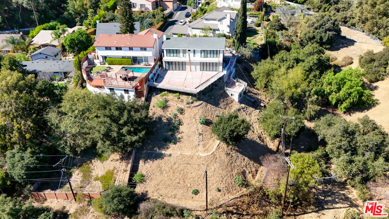 an aerial view of a house with a yard and garden