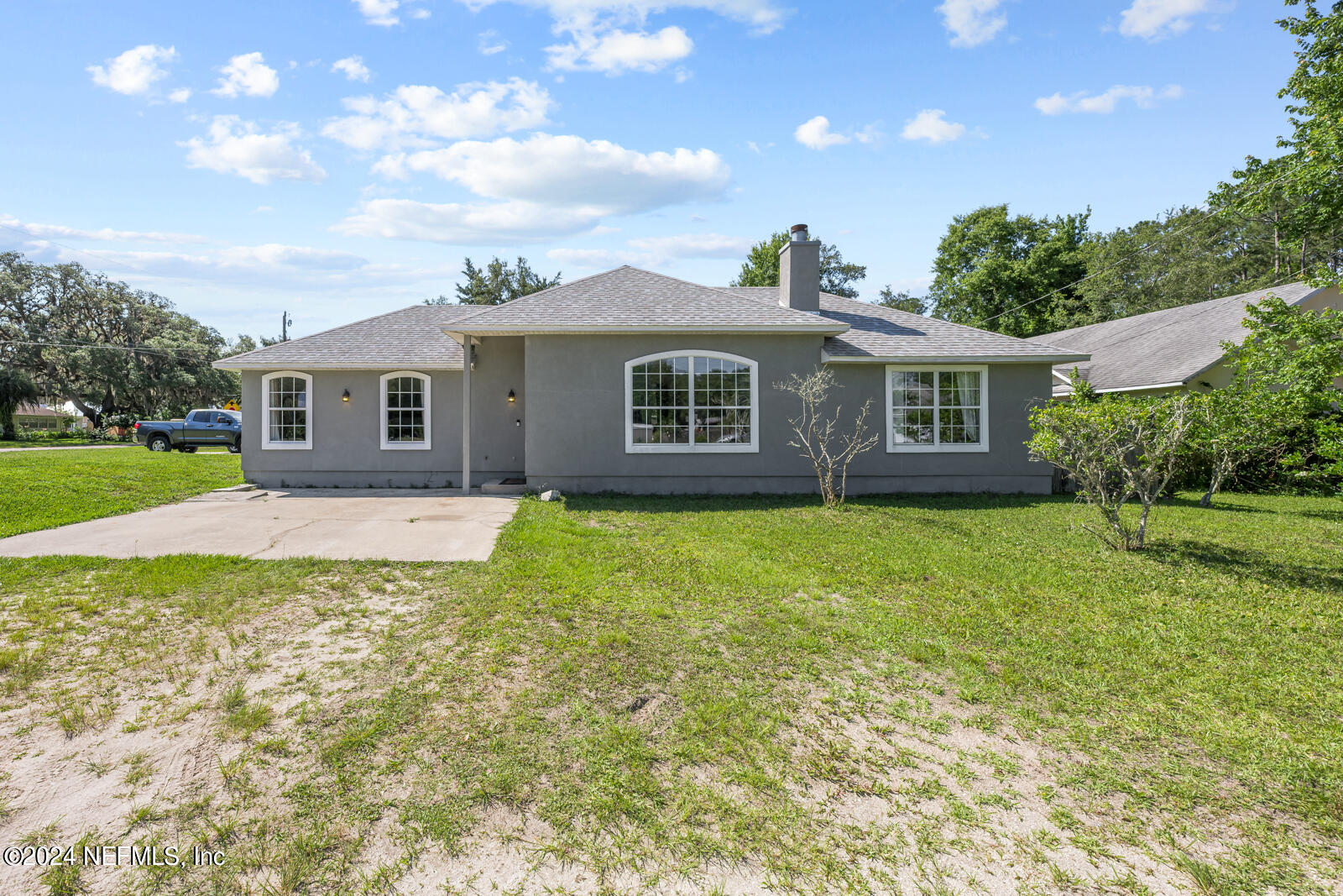 a front view of house with yard and green space