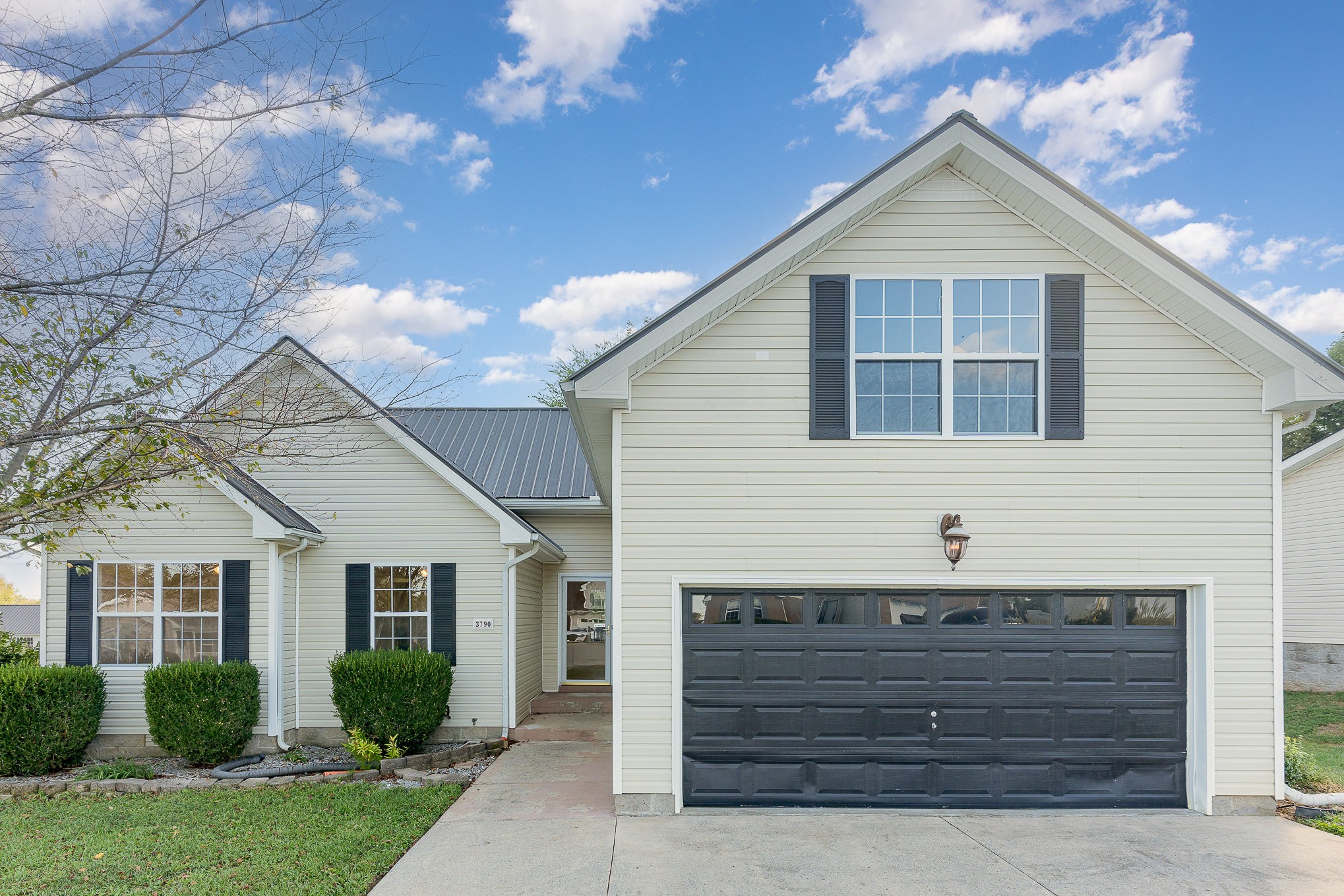 a view of house with a yard