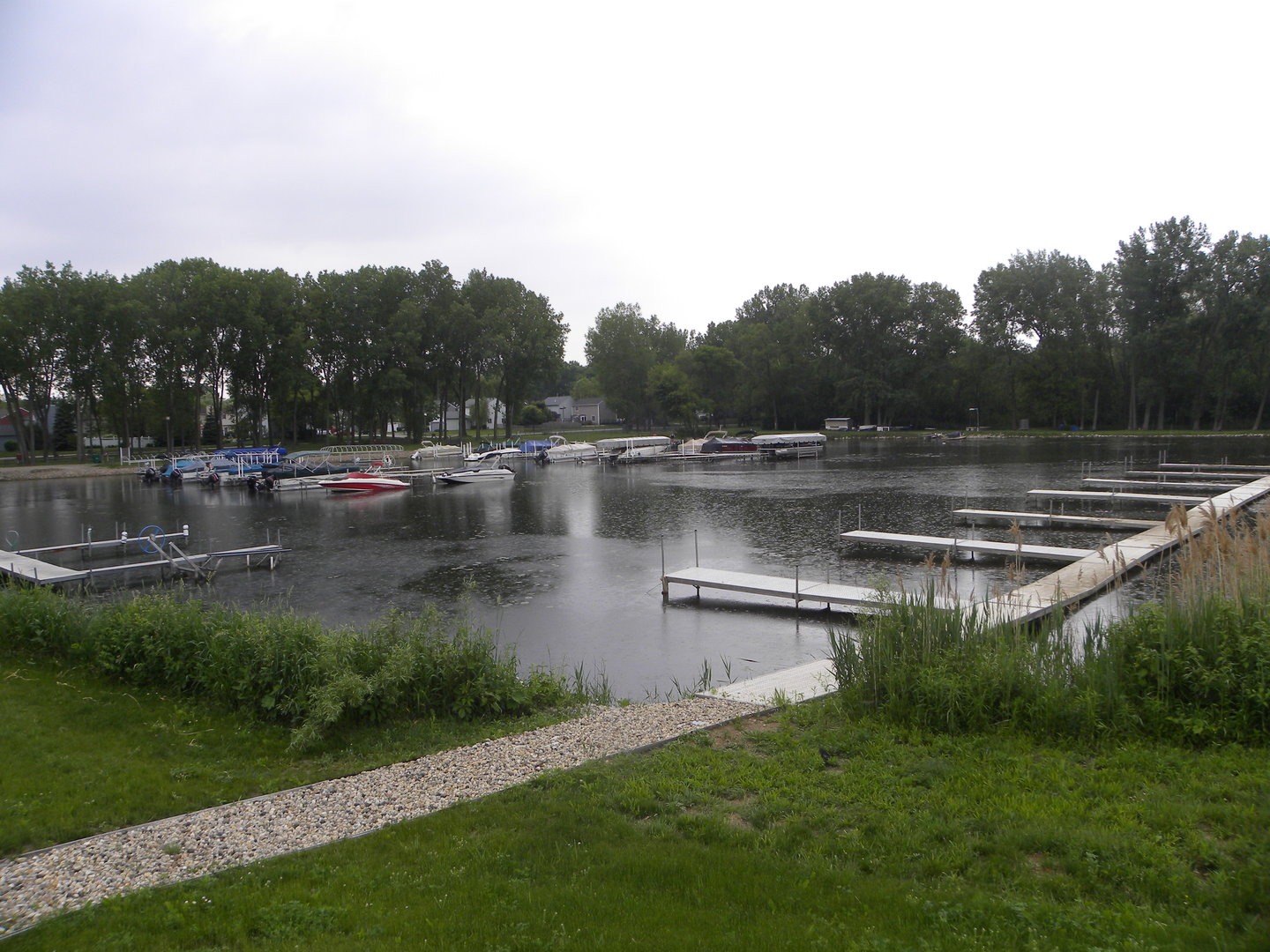 a view of a water pond with green yard