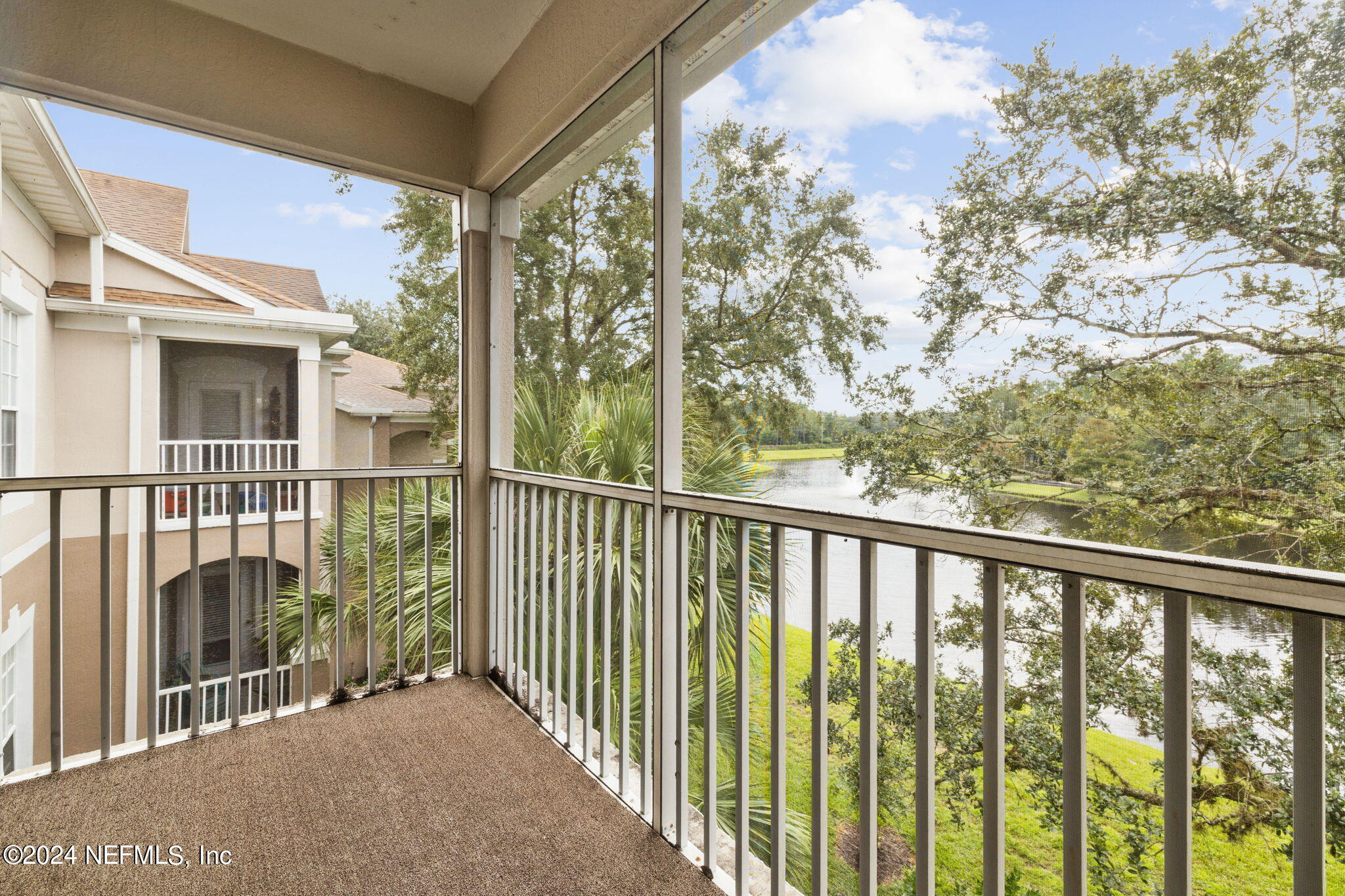 a view of a balcony with a floor to ceiling window and wooden fence