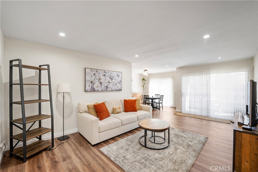 a living room with furniture a rug and a large window