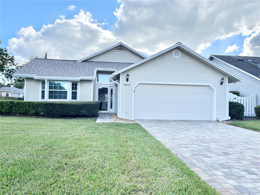 a view of a house with a yard and garage