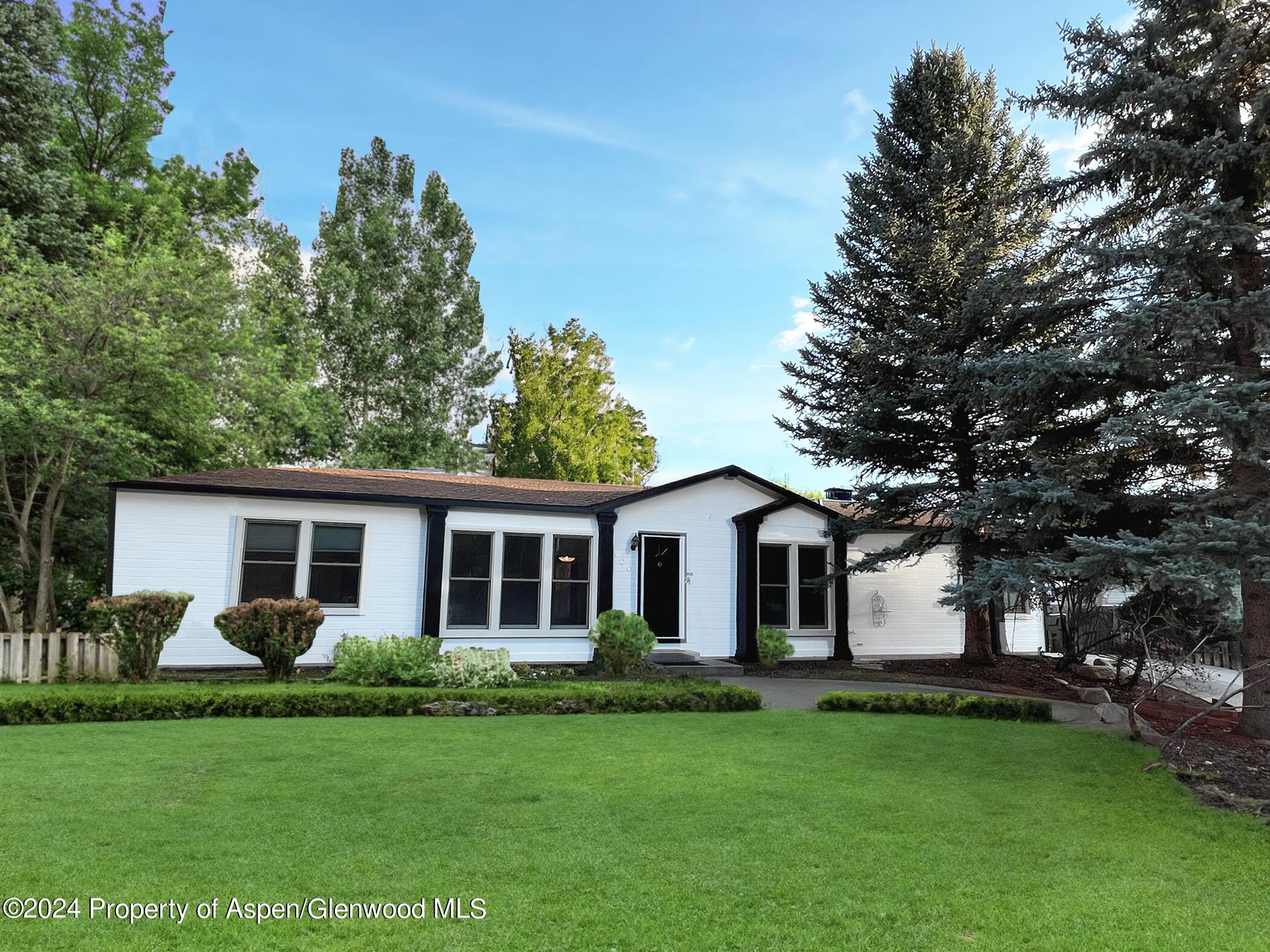 a front view of house with a garden and patio