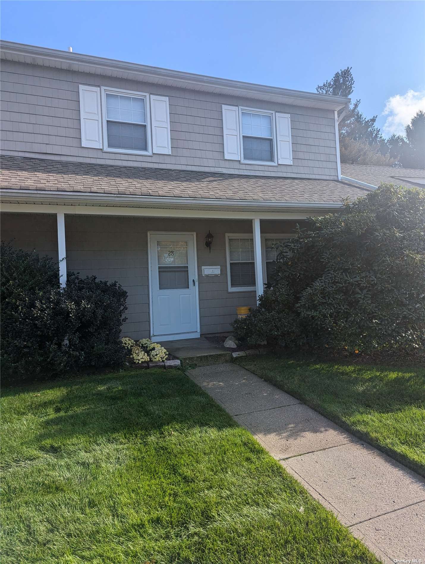 a front view of a house with a garden