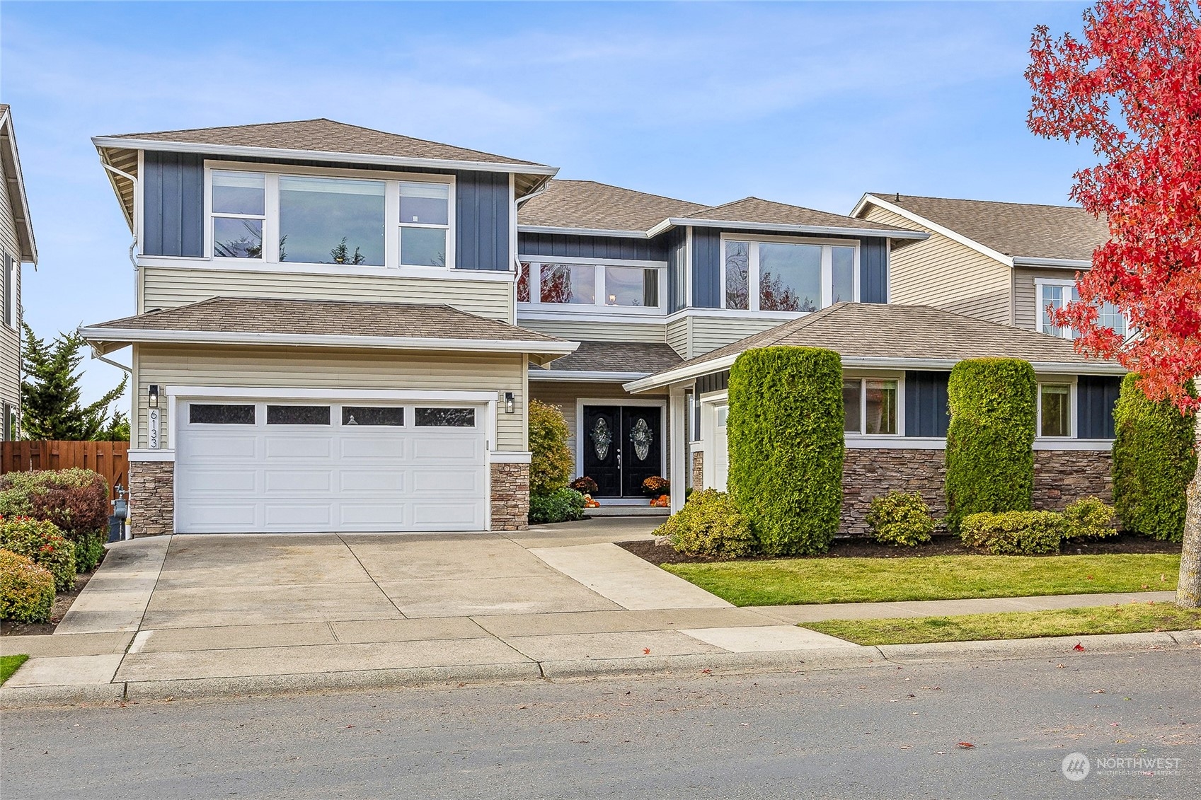 a front view of a house with a garden