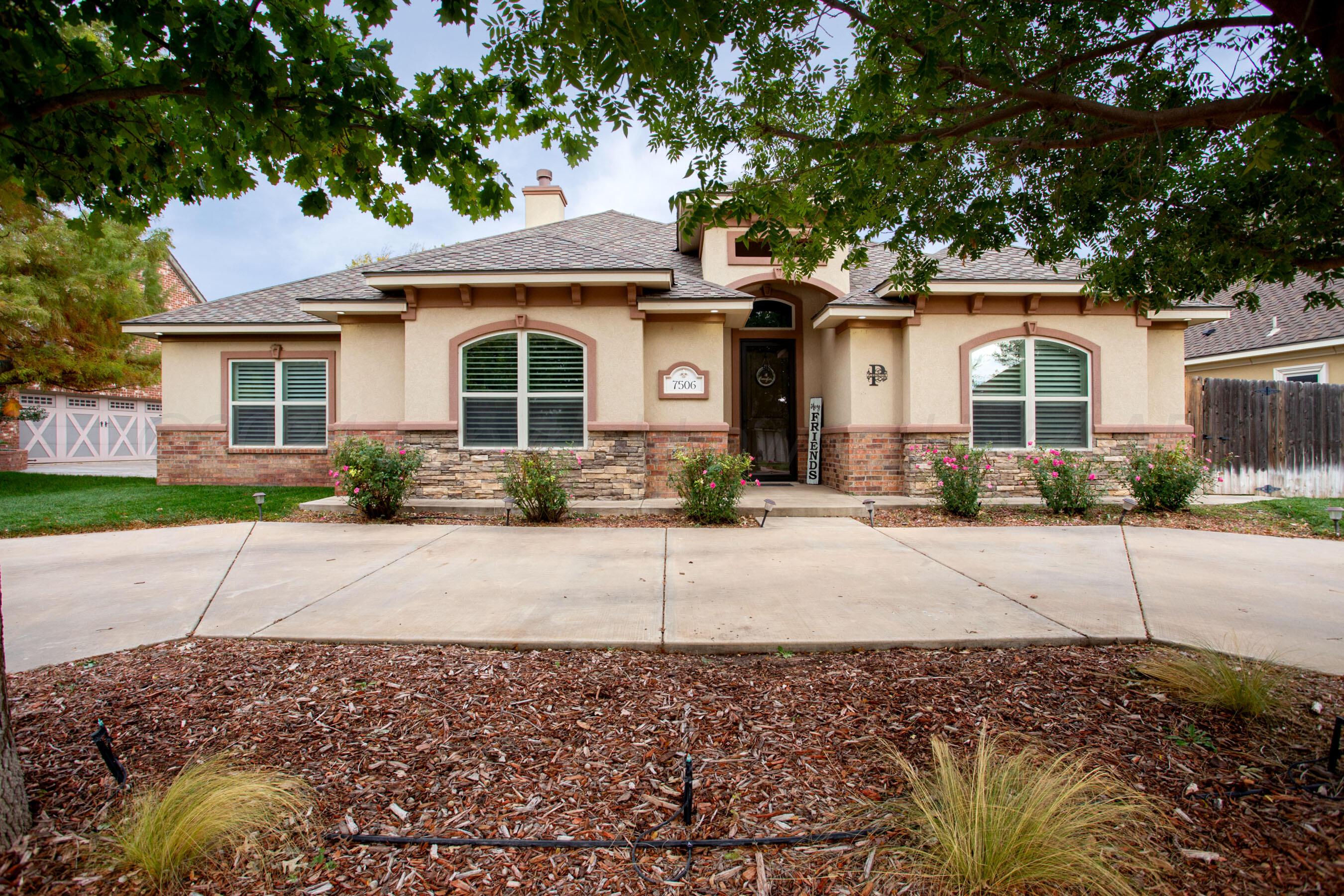 a front view of a house with a yard and a garage